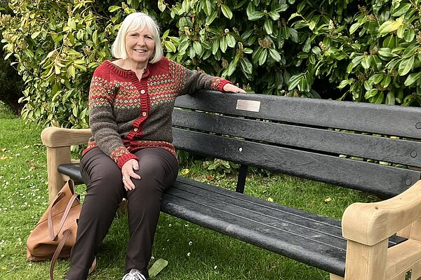 Lesley Paine on a new bench at the Lower Sheering play area